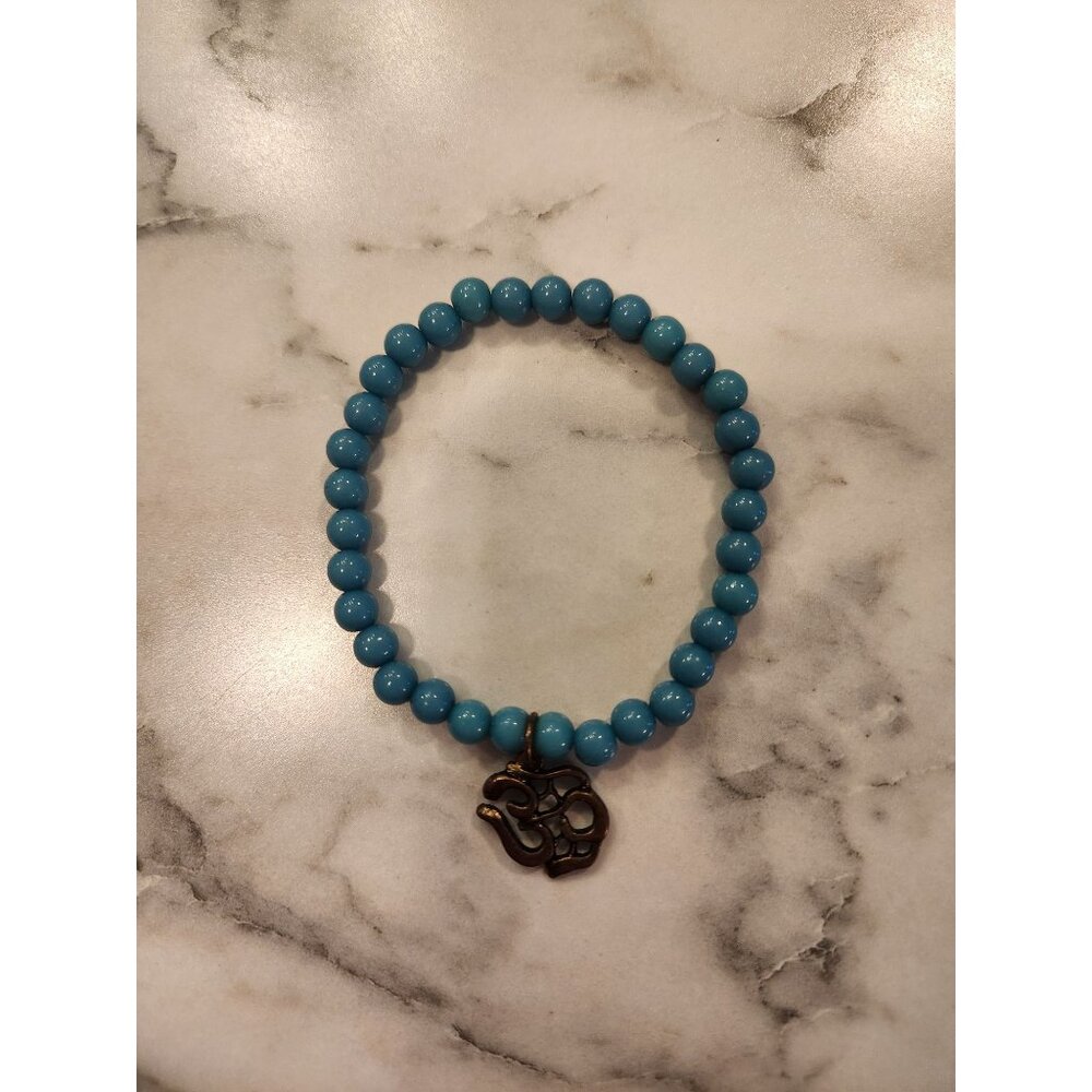 Turquoise Blue Beaded Bracelet With Bronze Om Symbol Charm